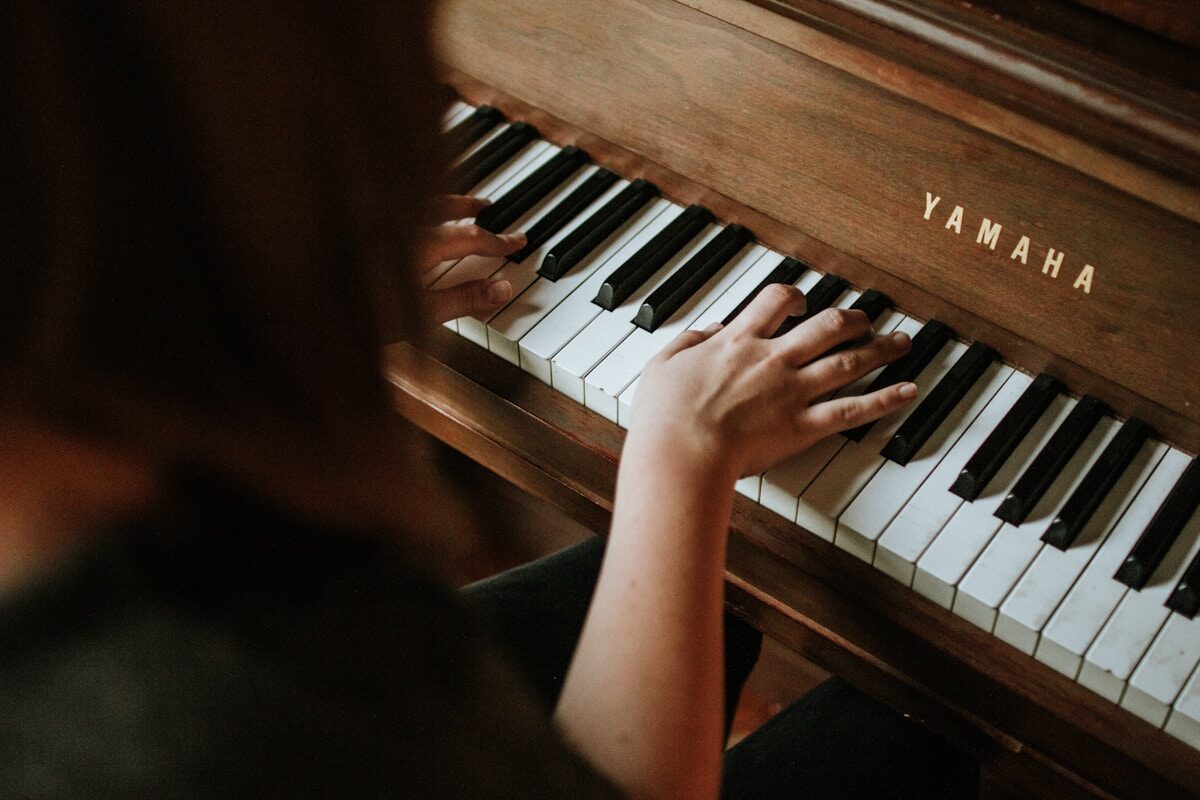 Hands positioned on piano keys